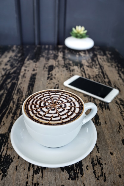 Cups of mocha coffee on wood table