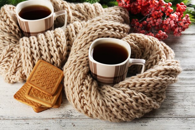 Cups of tea with cookies on table close-up