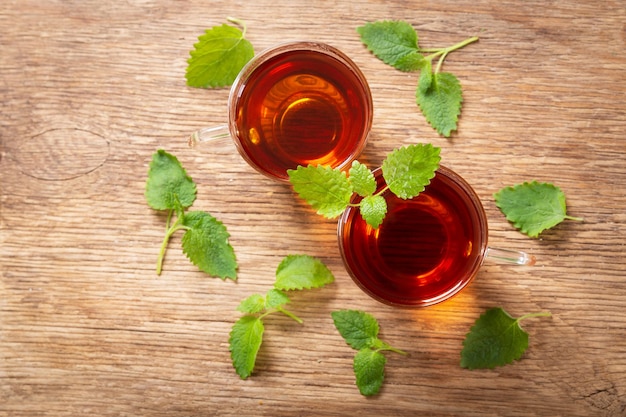 Cups of tea with mint leaves top view