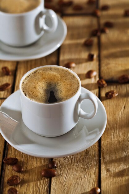 Cups with coffee on old table