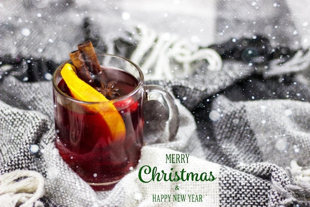 Cups with hot mulled wine on a wooden background. New year concept