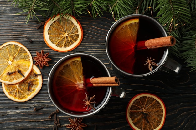 Cups with mulled wine, ingredients and pine branches