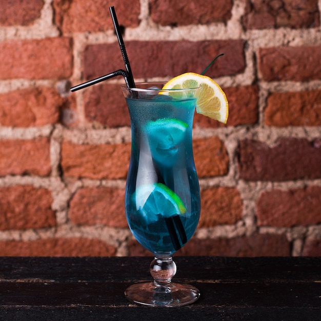 Curassao blue cocktail with lemon in a glass goblet