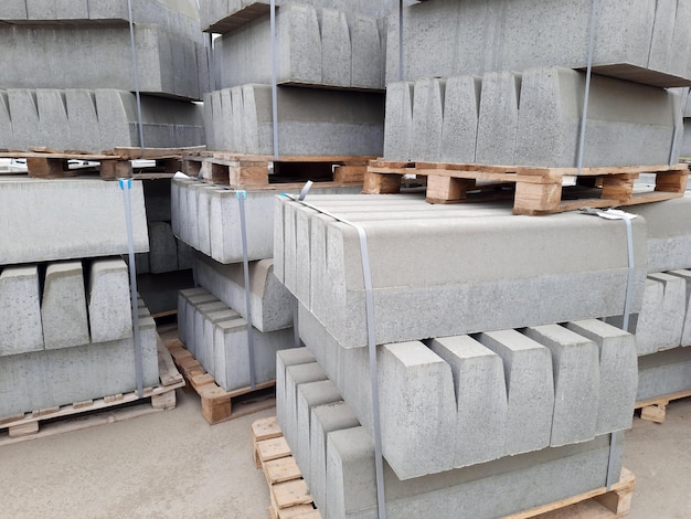 Curbs new blocks for laying stacked in piles on wooden pallets