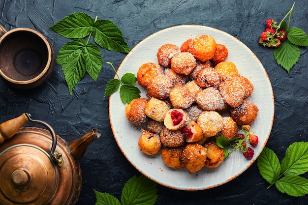 Curd donuts with raspberries for tea