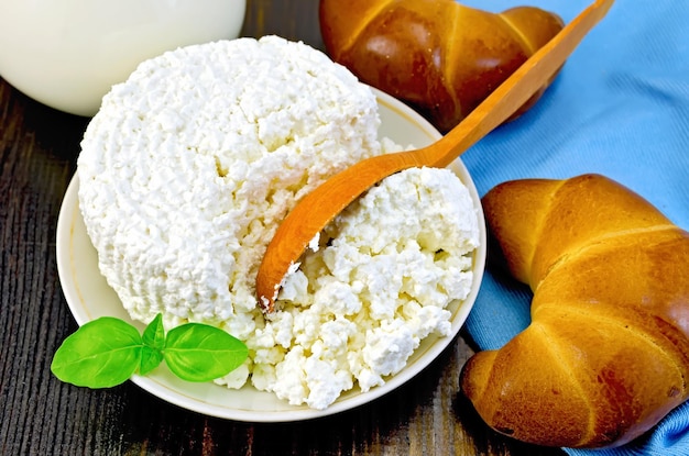 Curd with a wooden spoon and bagel on the board