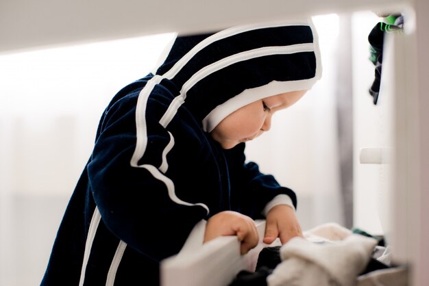 Curious baby opens the closet