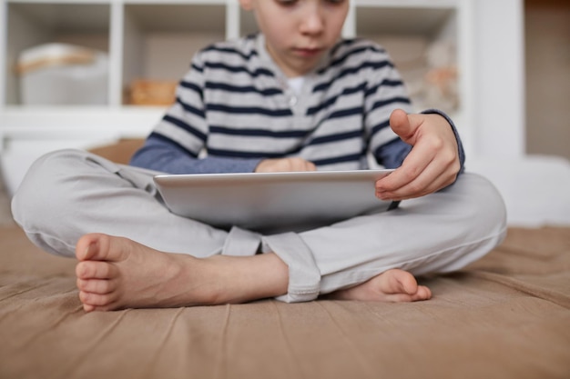 Curious child scrolling on tablet