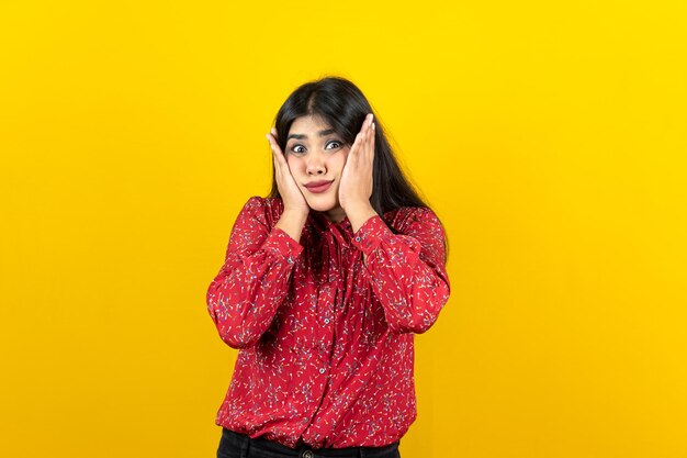 Curious pretty woman with glad expression isolated on yellow background