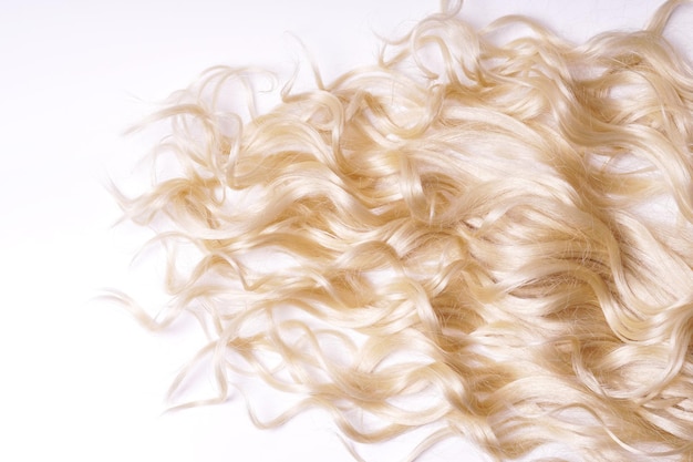 Curly blond hair on white background