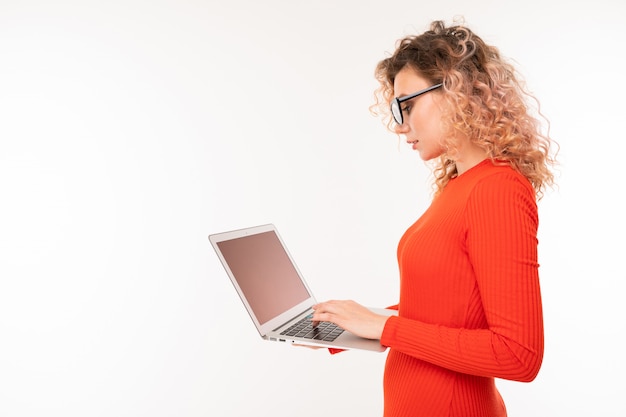 curly girl holding a laptop in her hands on white