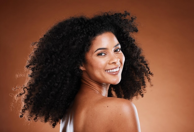 Curly hair black woman and natural skincare beauty and makeup glowing skin and facial cosmetics aesthetic wellness and studio background Portrait of happy young african model afro and body care
