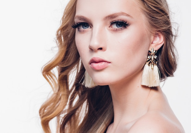 Curly hair blonde woman with long beautiful hairstyle and beauty lashes isolated on white. Studio shot.