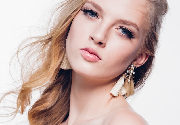 Curly hair blonde woman with long beautiful hairstyle and beauty lashes isolated on white. Studio shot.