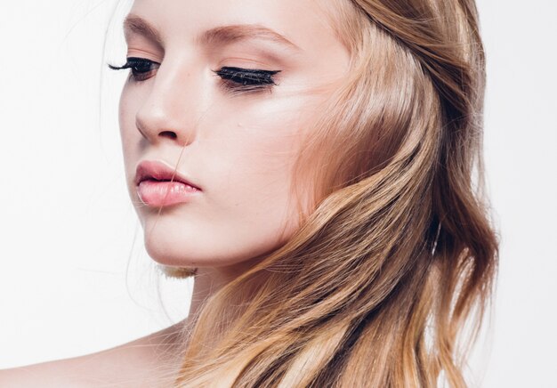 Curly hair blonde woman with long beautiful hairstyle and beauty lashes isolated on white. Studio shot.