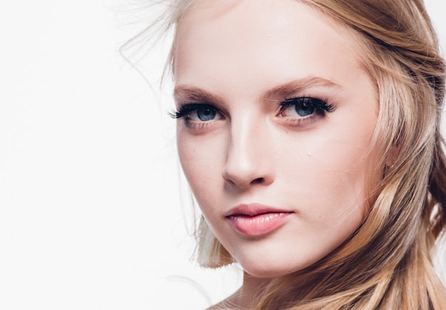 Curly hair blonde woman with long beautiful hairstyle and beauty lashes isolated on white. Studio shot.