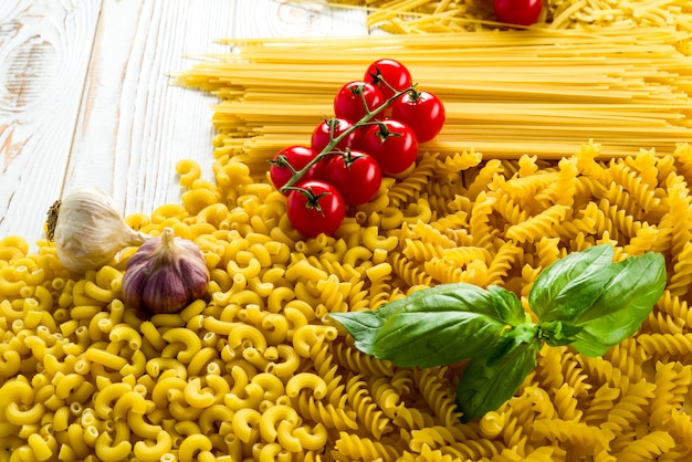 curly pasta and basil leaf on the table