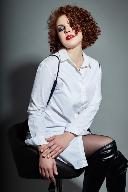 Curly redhead adult sexy woman in white shirt 