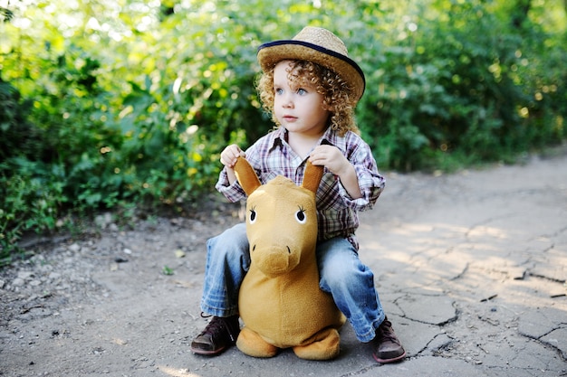 Curly redhead child in a straw hat