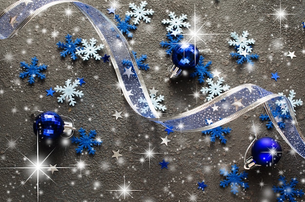 Curly ribbon with decorative balls and snowflakes