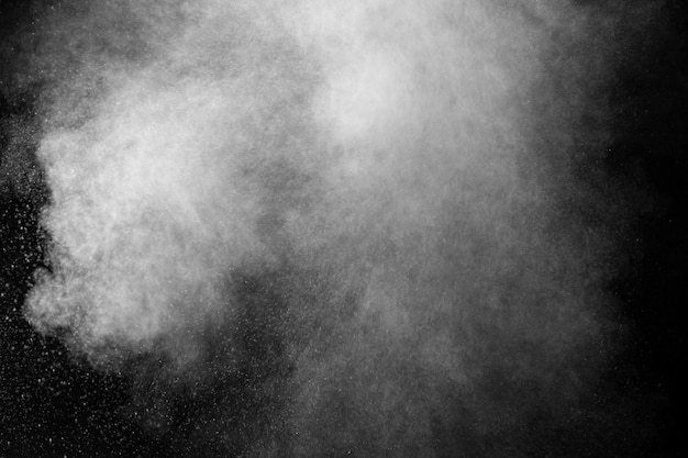 Curly white steam rising up and splashing water scattering in different directions isolated on a black background to overlay