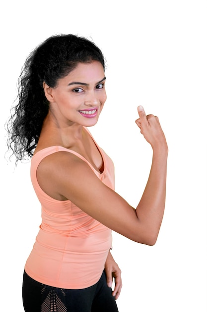 Curly woman shows her muscular bicep and thumb up