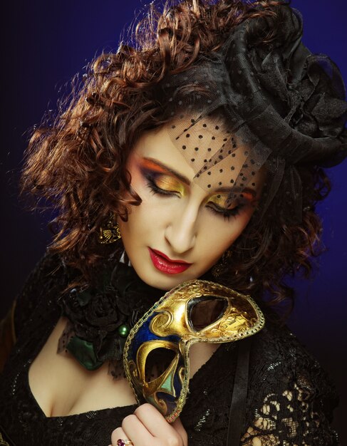 Curly woman with mask. Carnaval visage.