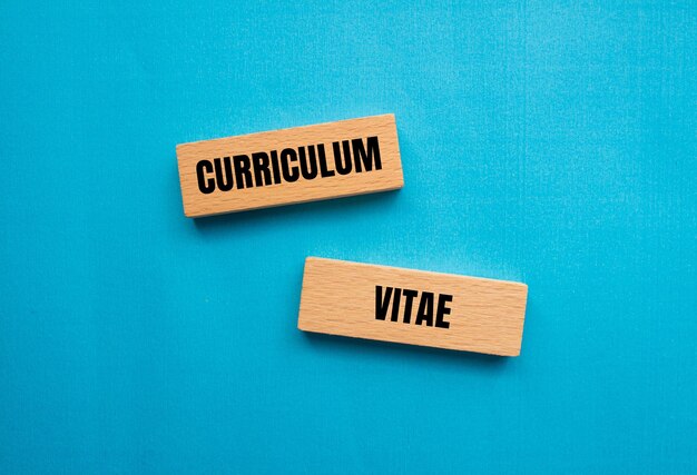 Foto curriculum vitae woorden geschreven op houten blokken met blauwe achtergrond conceptueel curriculum vitae cv-symbool kopieerruimte