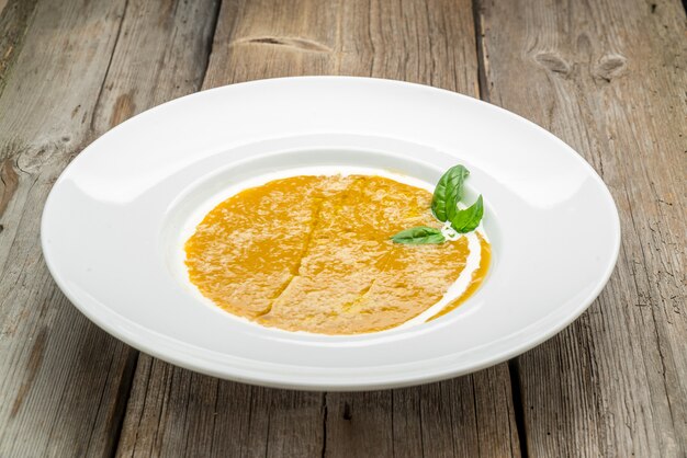 Curried carrot soup with cream and fresh herbs