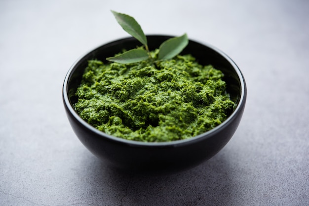 Curry leaves or kadi patta chutney in a bowl