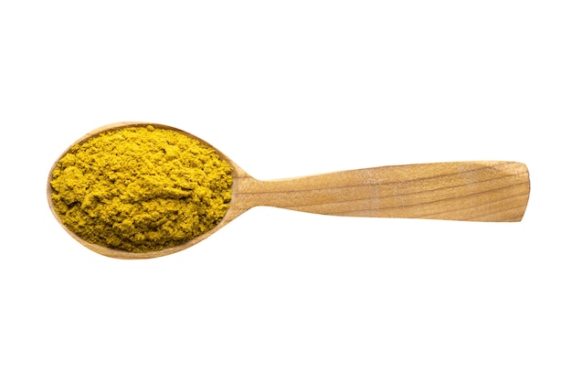 Curry powder for adding to food spice in wooden spoon