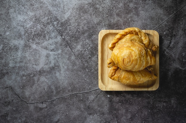 Photo curry puff pastry on concrete.
