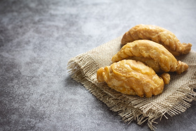 Photo curry puff pastry on concrete.