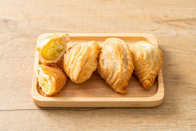 curry puff pastry stuffed beans on wooden plate