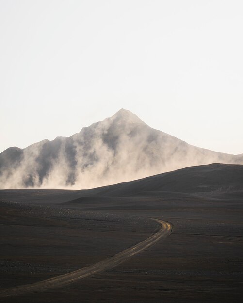 Curve road with a misty volcanic drone shot