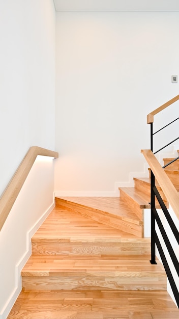 The curved staircase uses natural wood color as its material