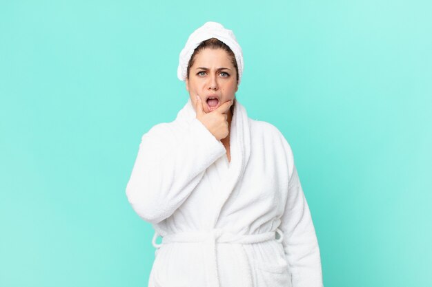 Curvy pretty woman after a shower wearing bathrobe