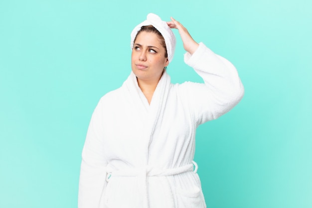 Curvy pretty woman after a shower wearing bathrobe