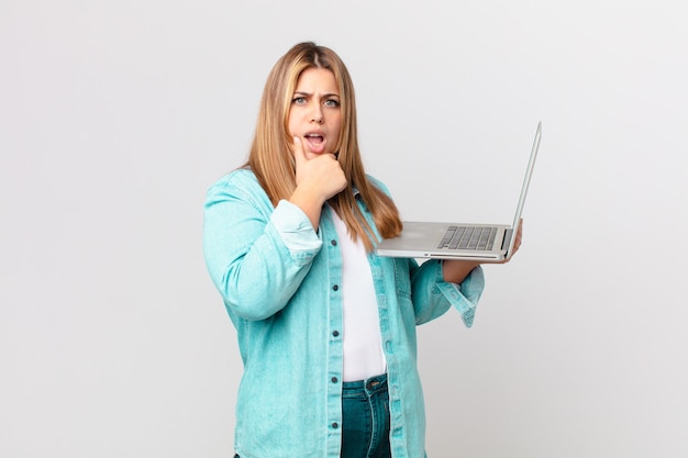 Curvy pretty woman holding a laptop