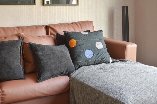 Photo cushions on sofa in living room at home