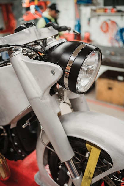 Custom motorcycle standing in repair shop