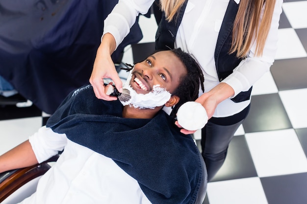 Customer at barber shop with shaving cream