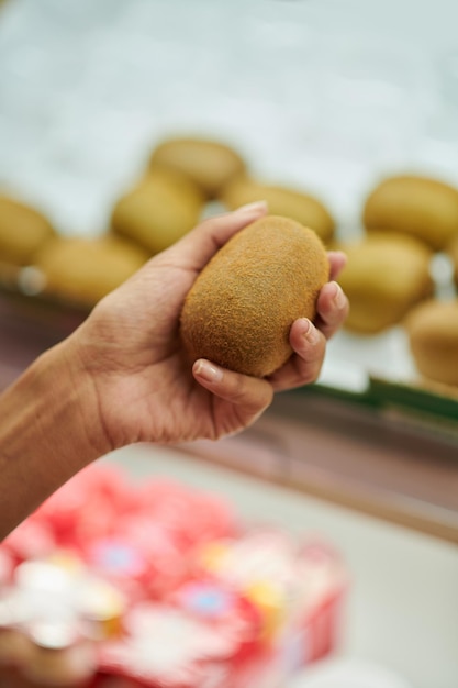 Customer Buying Fresh Kiwi