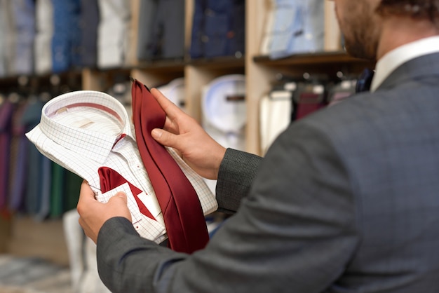 Customer choosing festive clothes for special occasion.