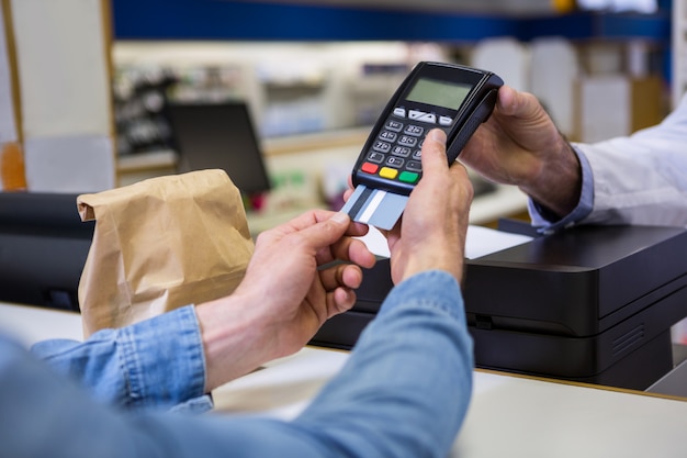 Customer entering pin in payment terminal machine