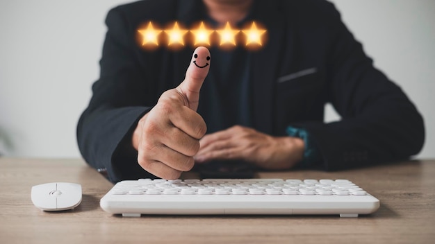 Customer experience satisfaction concept customer hand with thumb up Positive emotion smiley face icon and five star with copy space Best Excellent Services Rating for Satisfaction