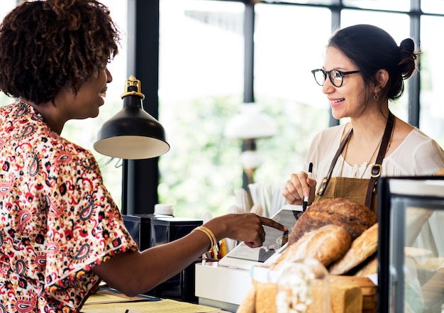 Customer ordering pastry at counter