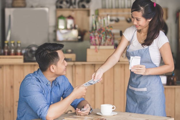 Customer paying by cash in a cafe