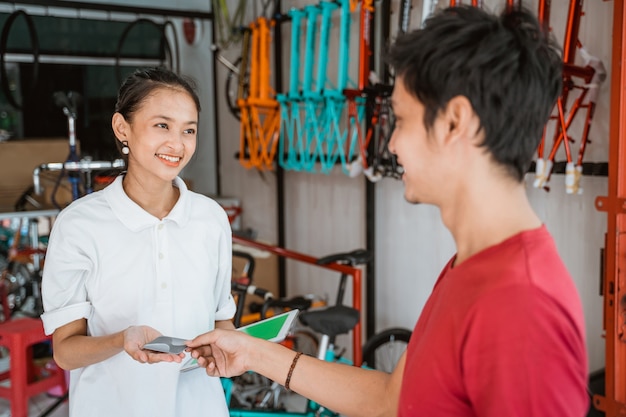 Customer paying with credit card while buying a bicycle