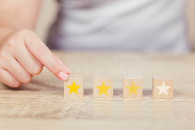 Customer pressing star on wood cube